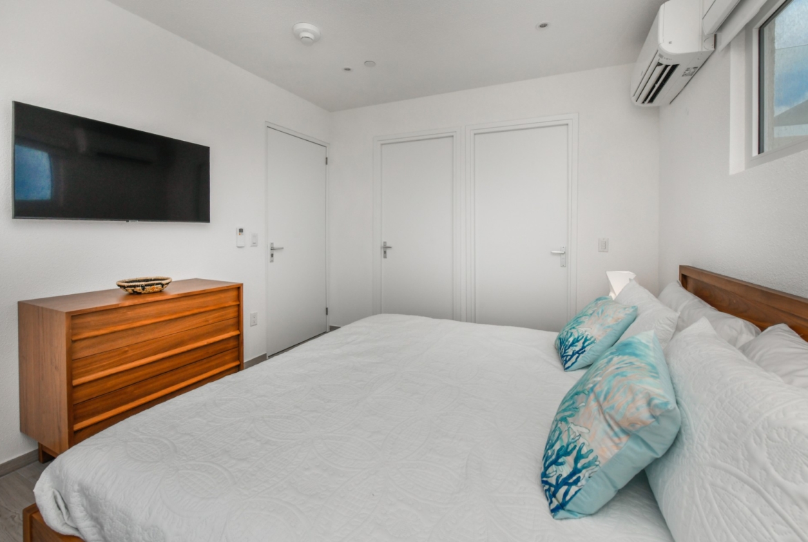 cozy modern bedroom at Commandeurs in Aruba For Sale, Res Realty