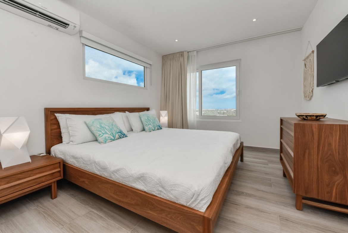 cozy modern bedroom at Commandeurs Unit 7 in Aruba For Sale
